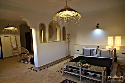 a living room with a couch and a table at Sunrise Palace Merzouga in Merzouga