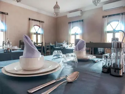 a table with two white hats on top of it at Dar Morocco in Merzouga