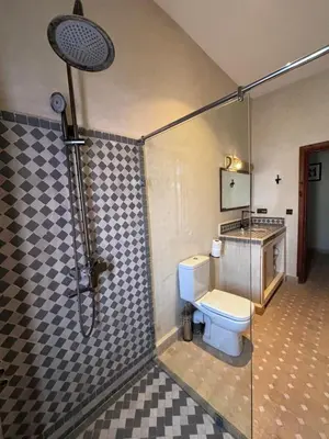 a bathroom with a shower with a toilet in it at Dar Morocco in Merzouga