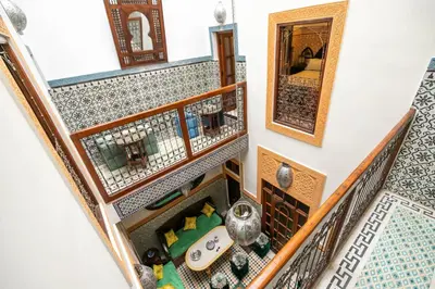 an overhead view of a staircase with a mirror and vases at Riad Dar Barae in Fès al Bali