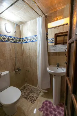 a small bathroom with a toilet and a sink at Riad Dar Barae in Fès al Bali