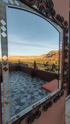 a mirror reflecting a room with a view at Guesthouse Panorama Todra in Tinerhir