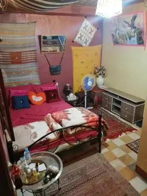 a bedroom with a bed and a table at Guesthouse Panorama Todra in Tinerhir