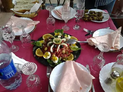 a table with a plate of food on a red table at Guesthouse Panorama Todra in Tinerhir