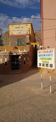 a sign in front of a building on a street at Guesthouse Panorama Todra in Tinerhir