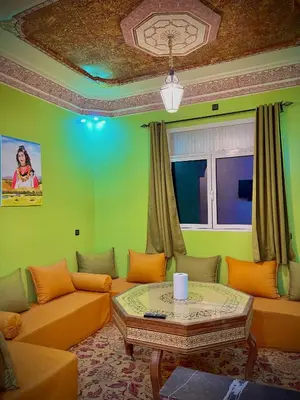 a living room with a couch and a table at Luxury Family Apartment in Merzouga