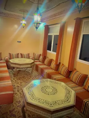 a living room with a couch and a table at Luxury Family Apartment in Merzouga
