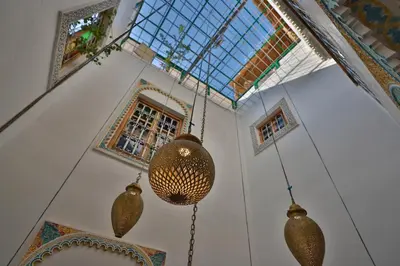 a room with three chandeliers hanging from a ceiling at Riad Moroccan Style in Fès