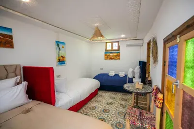 a room with a couch and a bed and a table at Riad Moroccan Style in Fès