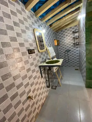 a bathroom with a sink and a mirror at Camp Auberge Sahara Marokko in Mhamid