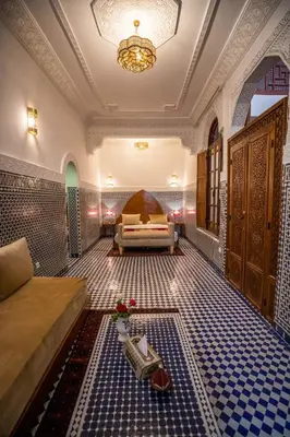 a living room with a couch and a table at Riad Dilar Fes & Spa in Fès