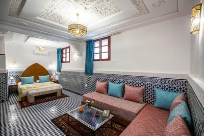 a living room with a couch and a table at Riad Dilar Fes & Spa in Fès