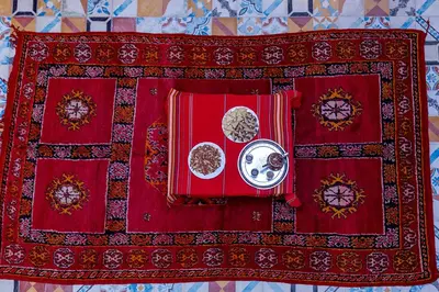 a table with red napkins and dishes on it at Dar Oussidi in Merzouga