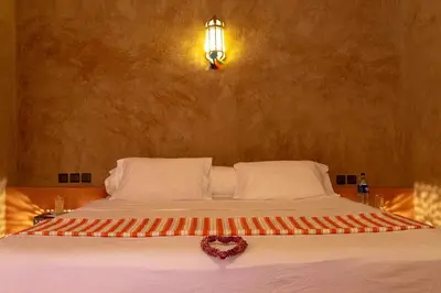 a bedroom with a bed with a heart on it at Dar Oussidi in Merzouga