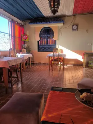 a restaurant with tables and chairs in a room at Jad Auberge in Ourika