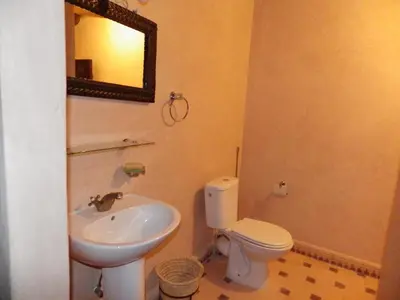 a bathroom with a sink and a toilet and a mirror at Jad Auberge in Ourika