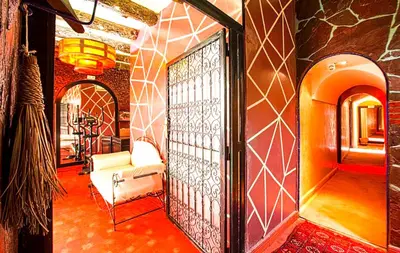 a room with a chair and a door in a room at Jad Auberge in Ourika