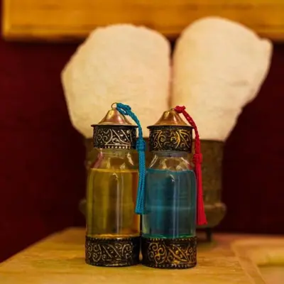 two bottles of oil sitting on a table at Merzouga Horizon Luxury Camp in Merzouga