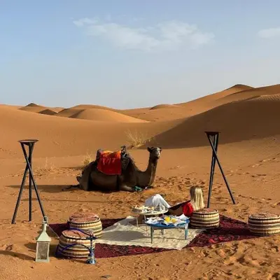 a group of children and a camel in the desert at Merzouga Horizon Luxury Camp in Merzouga