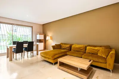 a living room with a couch and a table at Luxury Prestigia Close to Champs de Course Parc in Fès