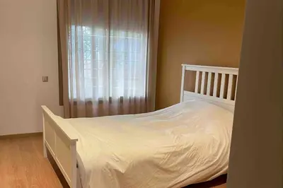 a bedroom with a white bed and a window at Luxury Prestigia Close to Champs de Course Parc in Fès