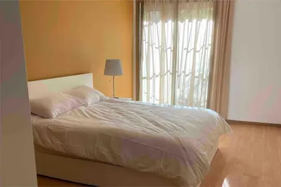 a bedroom with a bed and a large window at Luxury Prestigia Close to Champs de Course Parc in Fès