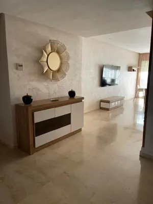 a living room with a large mirror on the wall at Luxury Prestigia Close to Champs de Course Parc in Fès