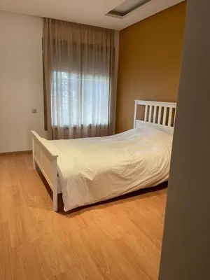 a bedroom with a white bed and a window at Luxury Prestigia Close to Champs de Course Parc in Fès