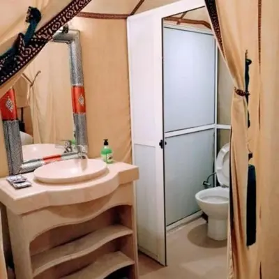 a bathroom with a sink and a toilet and a shower at Authentique merzouga camp in Merzouga
