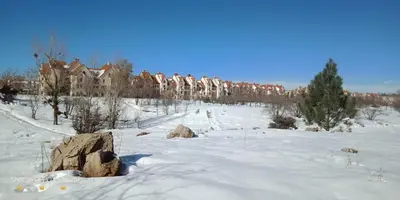 a snow covered field with houses in the background at Maison Jad in Ifrane