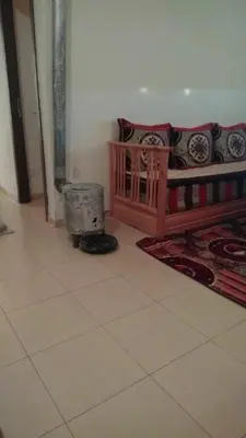 a living room with a couch and a heater at Maison Jad in Ifrane