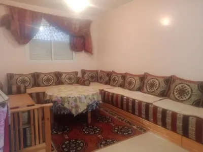 a living room with a couch and a table at Maison Jad in Ifrane