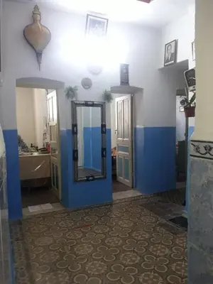 a bathroom with blue and white walls and a mirror at Hôtel Glacier in Fès