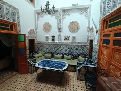 a living room with a couch and a table at RIaD DRISSIA Panoramic in Fès