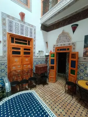 a room with blue and white tiled floors and wooden cabinets at RIaD DRISSIA Panoramic in Fès