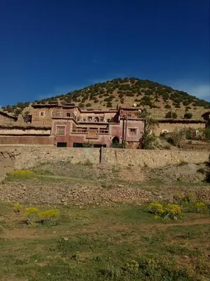 a large house on top of a hill at Gte Tawada - Haut-atlas - Chambre pour 2 Personnes in Ikhf nʼIghir