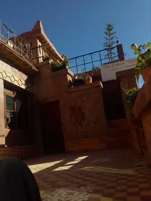 a house with a porch and a balcony on top of it at Gte Tawada - Haut-atlas - Chambre pour 2 Personnes in Ikhf nʼIghir