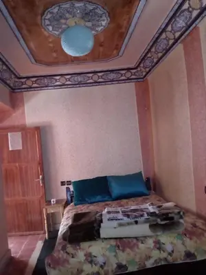 a bedroom with a bed with a coffered ceiling at Gte Tawada - Haut-atlas - Chambre pour 2 Personnes in Ikhf nʼIghir