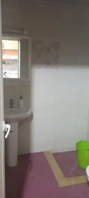 a bathroom with a sink and a toilet and a mirror at Dar abd essalam in Moulay Yacoub