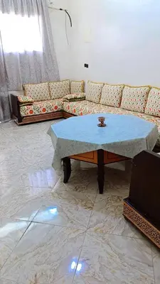 a living room with a couch and a table at Dar abd essalam in Moulay Yacoub
