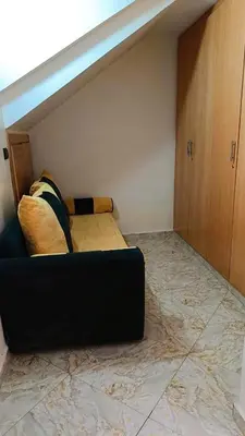a couch sitting on the floor in a room at Dar abd essalam in Moulay Yacoub