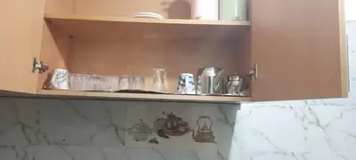 a cupboard with glasses and other items on it at Dar abd essalam in Moulay Yacoub