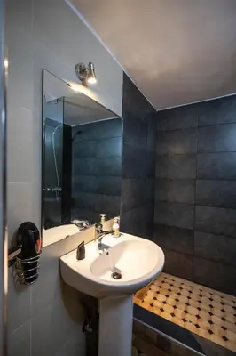 a bathroom with a sink and a mirror at Riad Soultana in Fès