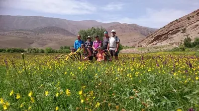 a group of people standing in a field of flowers at Gte Tawada - Valle Heureuse - Chambre pour 4 Personnes in Agouti