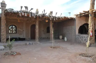 a house with birds sitting on top of it at Maison Acacias in Erfoud