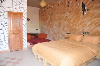 a bedroom with a large bed in a room at Maison Acacias in Erfoud