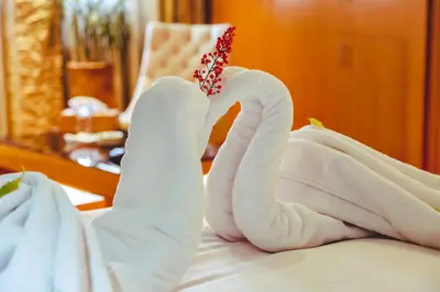 a swan made out of towels on a bed at Hotel Perce Neige in Ifrane