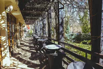 a row of tables and chairs on a balcony at Hotel Perce Neige in Ifrane
