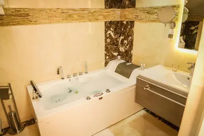 a bathroom with a tub and a sink at Hotel Perce Neige in Ifrane