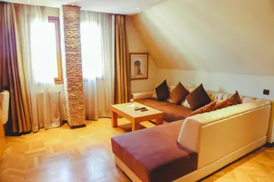 a living room with a couch and a table at Hotel Perce Neige in Ifrane